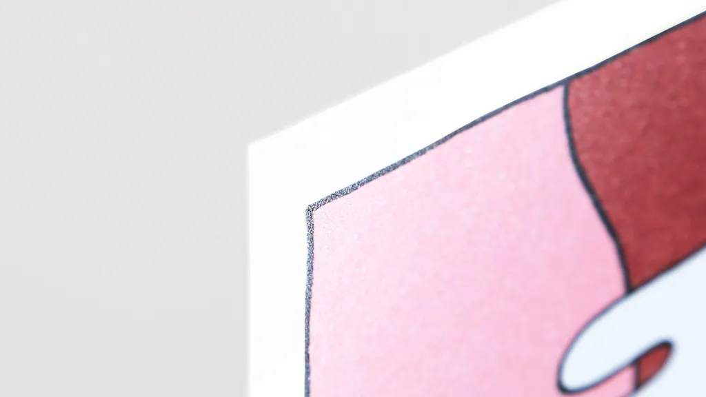 The corner of a custom cardstock sign printed with a pink and red design.