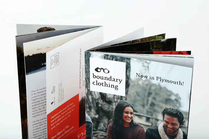 Two product catalogs standing with a saddle stitch binding and boundary clothing on the cover.
