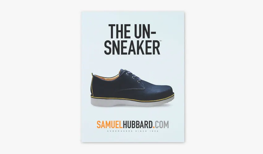 A custom styrene sign printed with The Un-Sneaker and an image of a shoe.