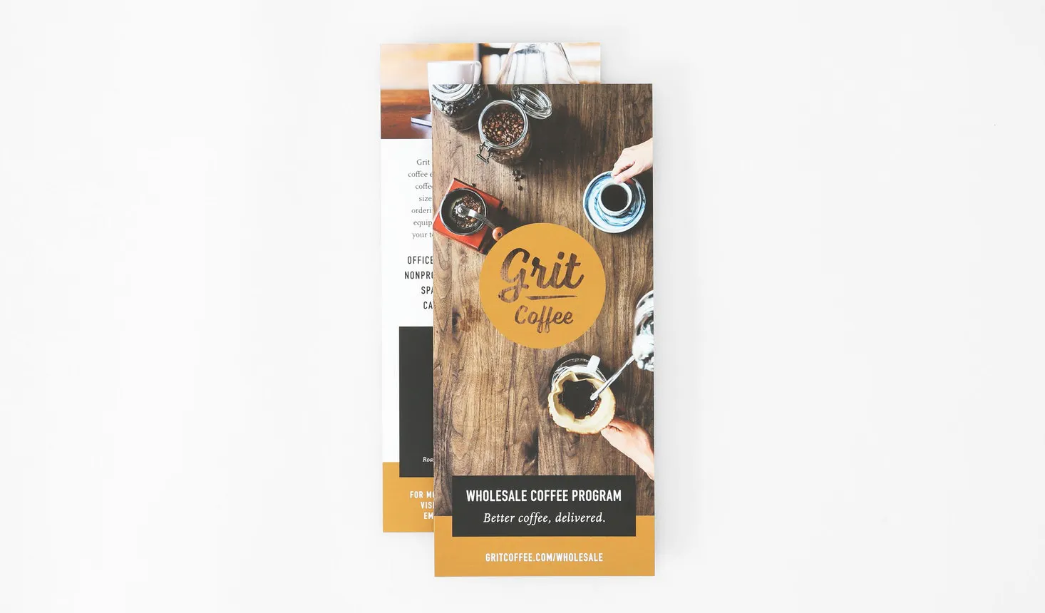 Two rack cards overlapping each other and printed with Grit Coffee's whole program details.