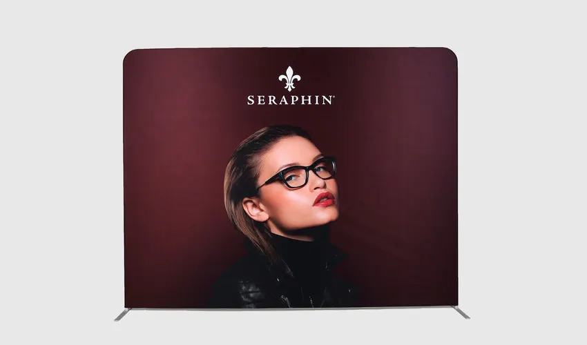 A tension fabric display printed with a dark red background, a woman wearing glasses and Seraphin in white.