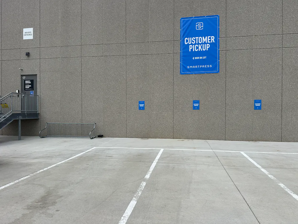 The customer pickup area at Smartpress, with blue signage on the building and door.
