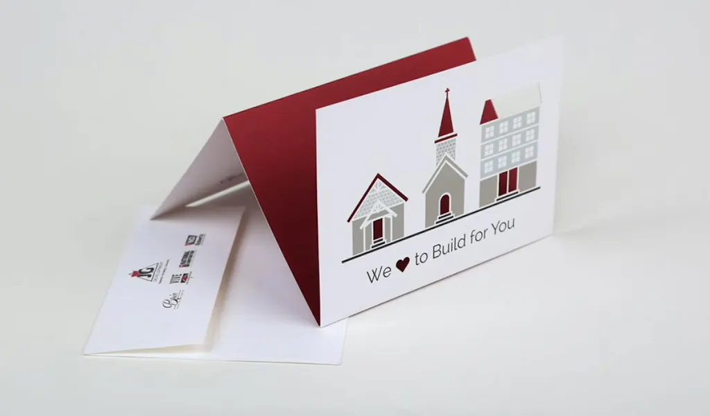 A direct mail card with three folds standing on top of a matching envelope.