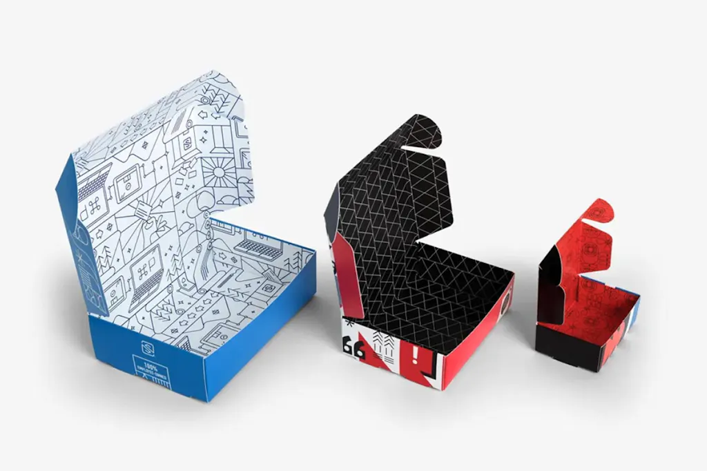 Three roll end boxes in various sizes with their lids open.